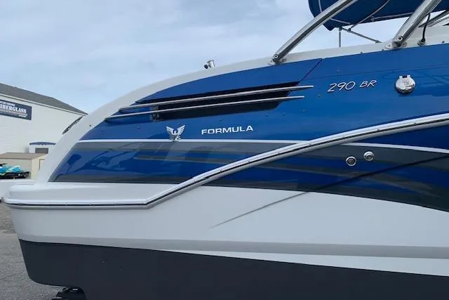 Slide: The Image of 2016 Formula 290 Bowrider boat, blue and white exterior, docked at a marina. - 14