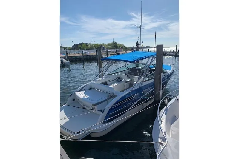 Slide: The Image of 2016 Formula 290 Bowrider with blue canopy docked at marina. - 8