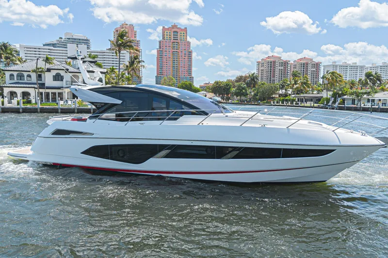 The Image of 2021 Sunseeker Predator 60 EVO yacht cruising near waterfront buildings. - 0