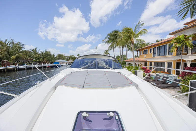 Slide: The Image of 2021 Sunseeker Predator 60 EVO yacht docked near luxury waterfront home. - 13