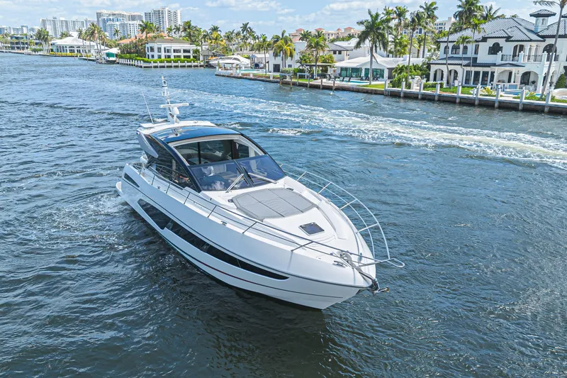 Slide: The Image of 2021 Sunseeker Predator 60 EVO yacht cruising on a scenic waterway. - 14