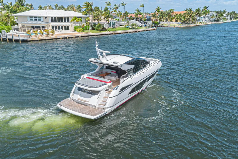 Slide: The Image of 2021 Sunseeker Predator 60 EVO yacht cruising on a scenic waterway. - 17