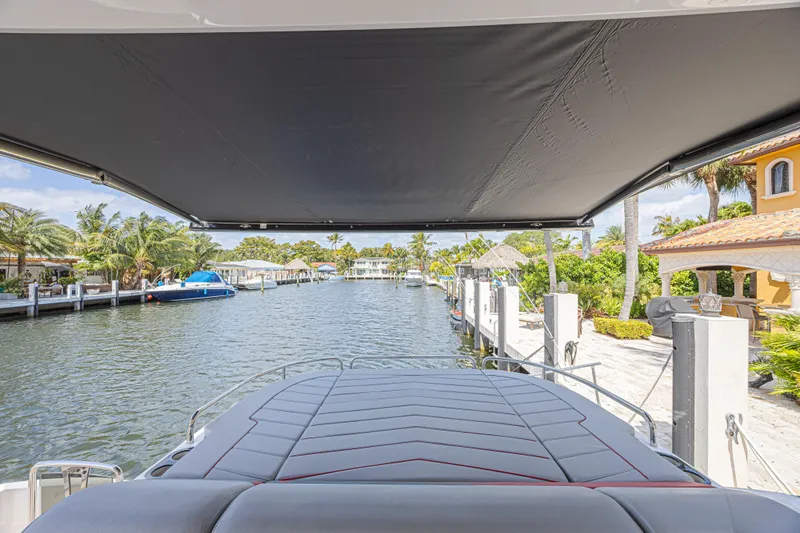 Slide: The Image of Sunseeker Predator 60 EVO yacht docked in a scenic waterfront location, 2021 model. - 19