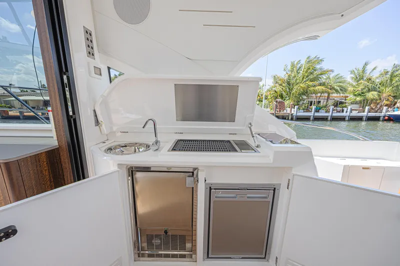 Slide: The Image of Outdoor kitchenette on 2021 Sunseeker Predator 60 EVO yacht with sink, grill, and fridge. - 23