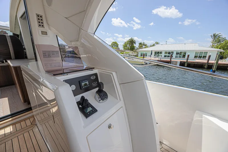 Slide: The Image of Control panel on 2021 Sunseeker Predator 60 EVO yacht, docked by waterfront building. - 24