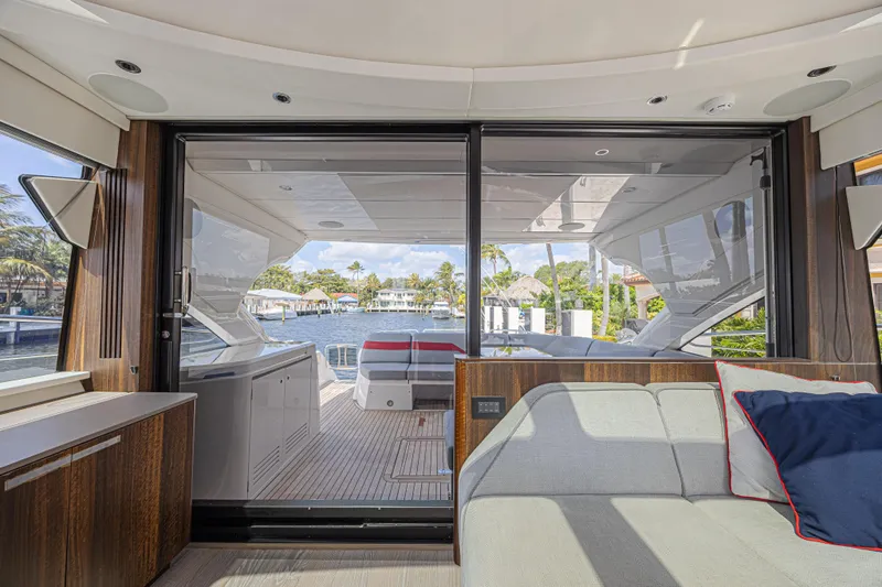 Slide: The Image of Interior view of 2021 Sunseeker Predator 60 EVO yacht, showcasing luxurious seating and waterfront. - 28