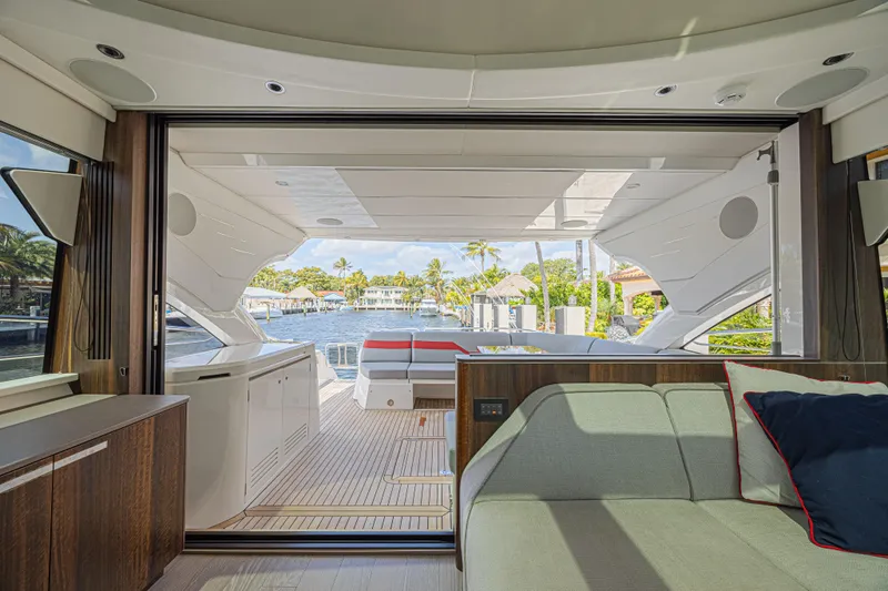 Slide: The Image of Interior view of 2021 Sunseeker Predator 60 EVO yacht, showcasing luxurious seating and open deck. - 29