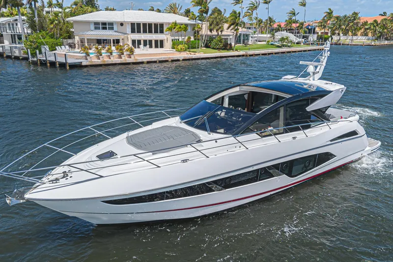 Slide: The Image of 2021 Sunseeker Predator 60 EVO yacht cruising near waterfront homes. - 3