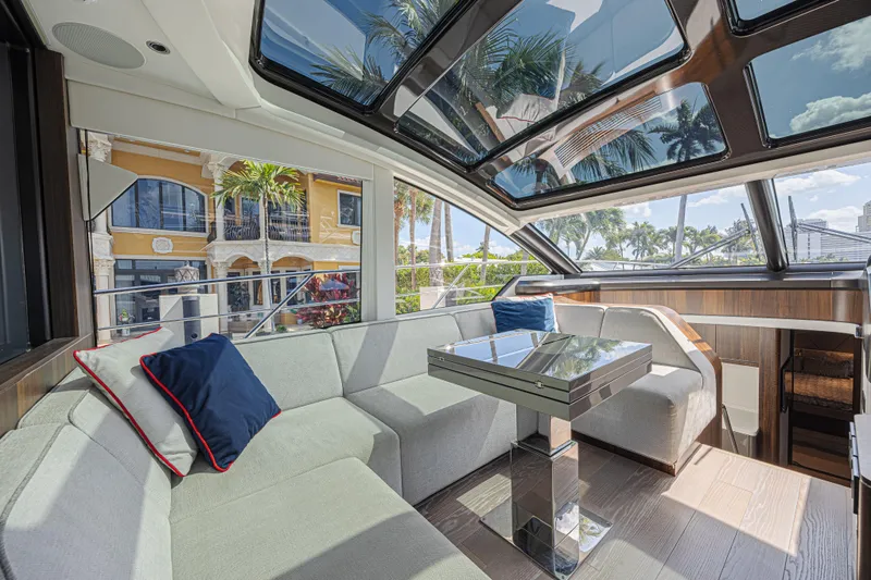 Slide: The Image of Luxurious interior of 2021 Sunseeker Predator 60 EVO yacht with panoramic windows and plush seating. - 32