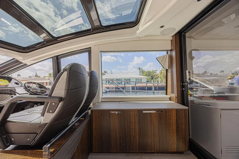 Slide: The Image of Interior view of 2021 Sunseeker Predator 60 EVO yacht with luxurious seating and panoramic windows. - 35