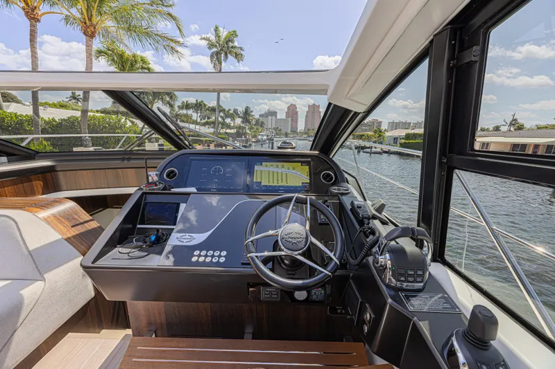 Slide: The Image of Helm of 2021 Sunseeker Predator 60 EVO yacht with modern controls and waterfront view. - 36