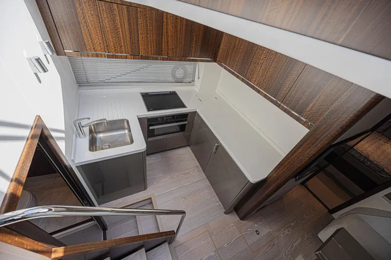 Slide: The Image of Modern kitchen interior of 2021 Sunseeker Predator 60 EVO yacht, featuring sleek design and wood accents. - 40
