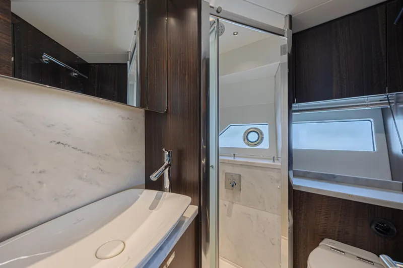 Slide: The Image of Luxurious bathroom in 2021 Sunseeker Predator 60 EVO yacht, featuring modern fixtures and elegant design. - 48