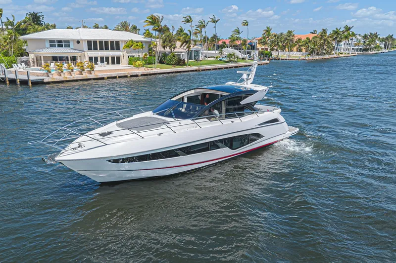 Slide: The Image of 2021 Sunseeker Predator 60 EVO yacht cruising on a sunny waterfront. - 7