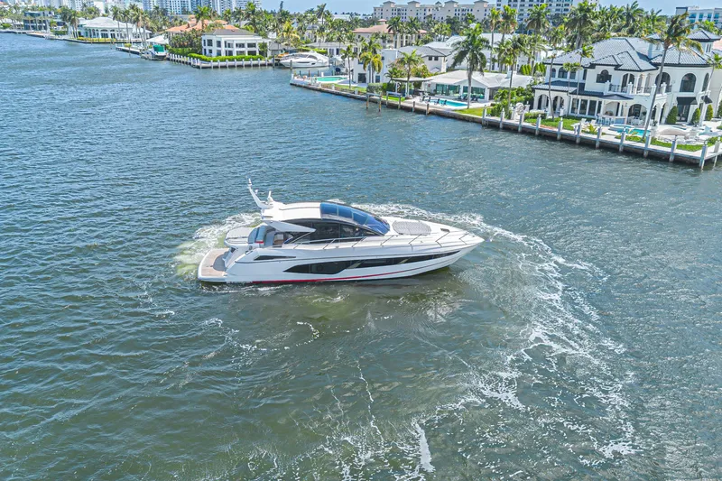 Slide: The Image of 2021 Sunseeker Predator 60 EVO yacht cruising near luxury waterfront homes. - 9