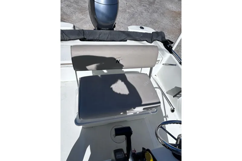Slide: The Image of 2016 NauticStar 1810 NauticBay boat interior with seating and steering wheel. - 3