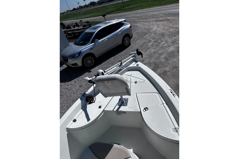 Slide: The Image of 2016 NauticStar 1810 NauticBay boat parked beside a silver car. - 4
