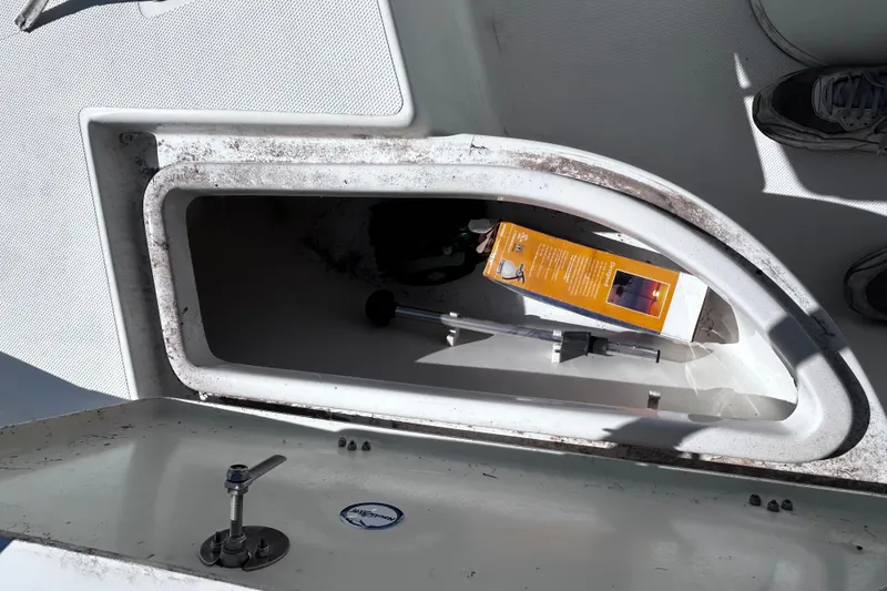 Slide: The Image of Open storage compartment on 2016 NauticStar 1810 NauticBay boat with items inside. - 6