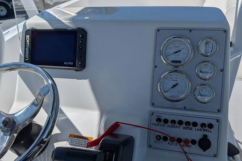 Slide: The Image of Clearwater 2000 Center Console 2022 boat dashboard with gauges and Lowrance Elite display. - 10