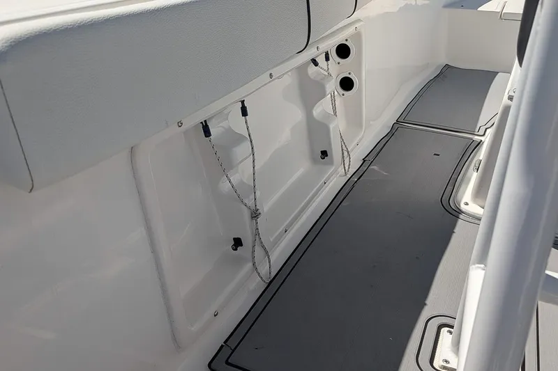 Slide: The Image of 2022 Clearwater 2000 Center Console boat interior with storage compartments and seating. - 11