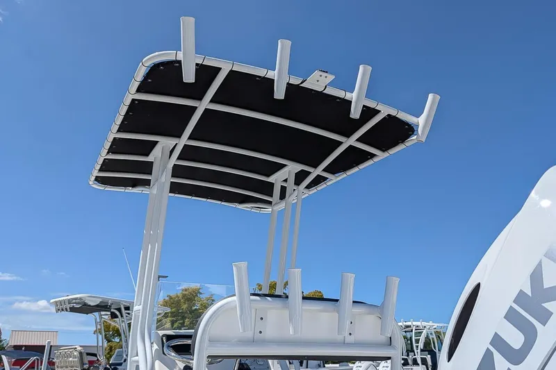 Slide: The Image of Clearwater 2000 Center Console boat, 2022 model, featuring a T-top under a clear blue sky. - 14