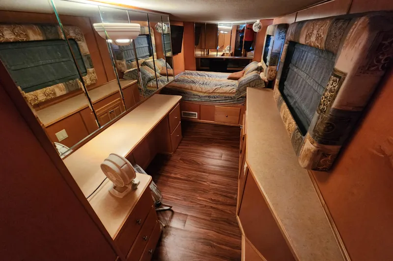 Slide: The Image of Interior of a 2000 Sharpe 85 houseboat bedroom with wood flooring and mirrored walls. - 20
