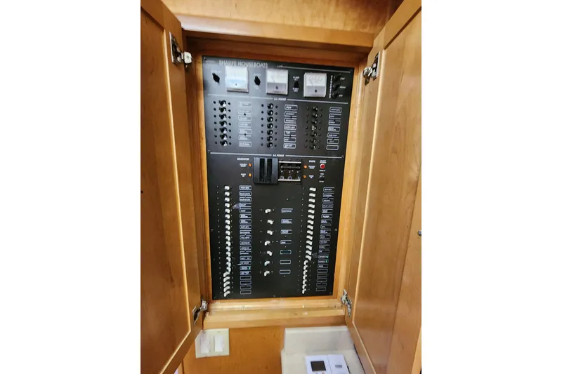 Slide: The Image of Electrical control panel inside a 2000 Sharpe 85 model, featuring switches and meters. - 23