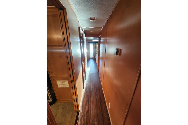 Slide: The Image of Narrow wooden hallway inside a 2000 Sharpe 85 model, featuring warm lighting and sleek design. - 28