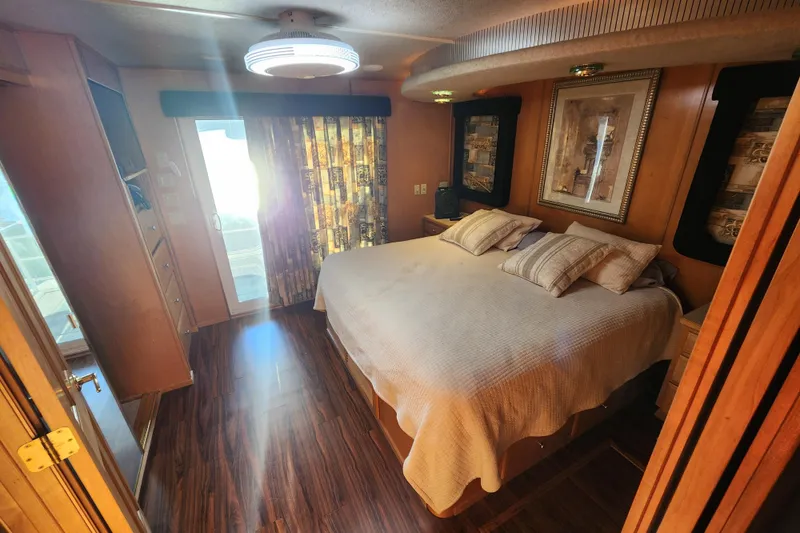 Slide: The Image of Luxurious bedroom in 2000 Sharpe 85 houseboat with elegant decor and natural lighting. - 30