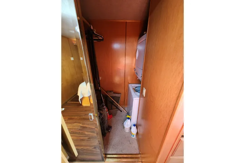 Slide: The Image of Laundry area in a 2000 Sharpe 85 model with stacked washer and dryer. - 33