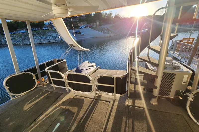 Slide: The Image of Houseboat deck with spiral staircase, slide, and sunset view over the water. Sharpe 85, 2000 model. - 34
