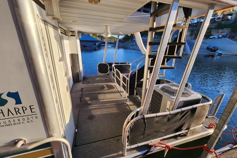Slide: The Image of Houseboat deck with stairs, air conditioning unit, and water view; Sharpe 85 model, year 2000. - 35