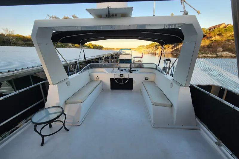 Slide: The Image of Upper deck of a 2000 Sharpe 85 houseboat with seating and a small table. - 36