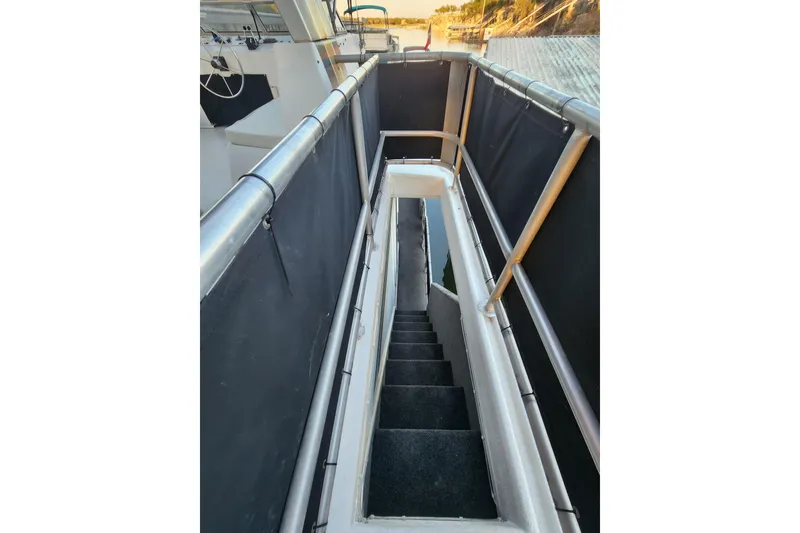Slide: The Image of Staircase on a 2000 Sharpe 85 boat with metal railings and black panels. - 38