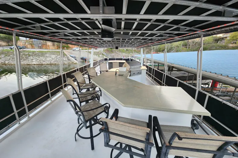 Slide: The Image of Spacious deck of 2000 Sharpe 85 houseboat with bar and seating area. - 39