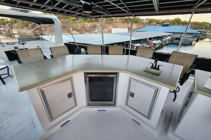 Slide: The Image of Luxurious yacht deck with bar, seating, and scenic marina view, Sharpe 85, year 2000. - 40