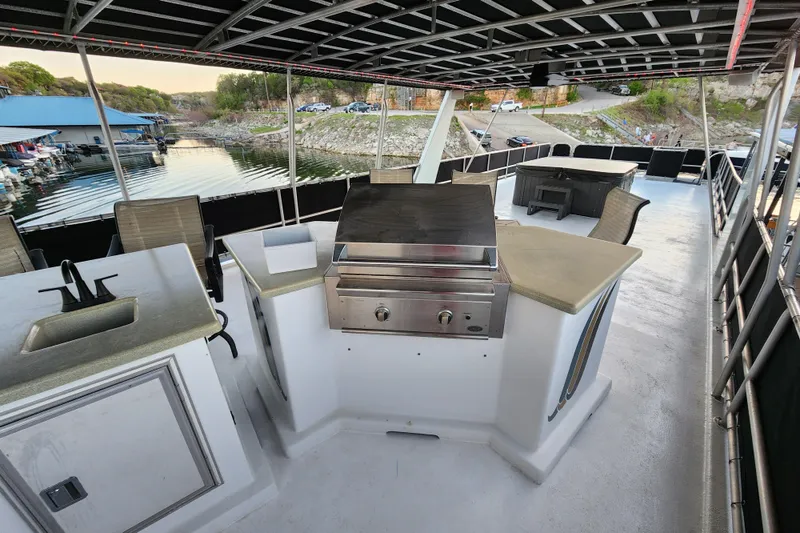 Slide: The Image of Outdoor kitchen on a 2000 Sharpe 85 houseboat with grill and seating area. - 41