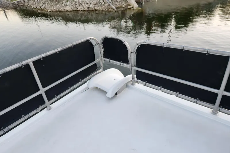 Slide: The Image of Deck of a 2000 Sharpe 85 boat with railing and water view. - 5