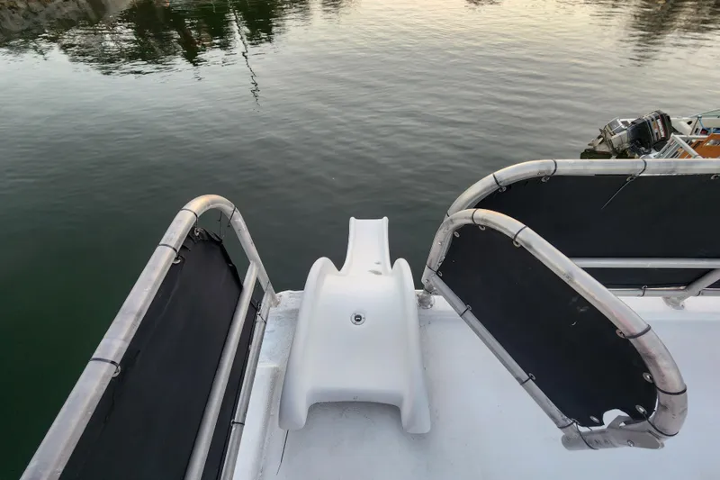 Slide: The Image of Boat deck with slide, Sharpe 85 model, 2000, overlooking calm water. - 6