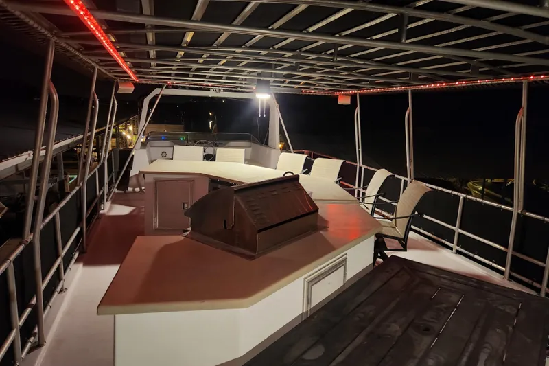 Slide: The Image of Rooftop deck of 2000 Sharpe 85 houseboat with seating and grill at night. - 7