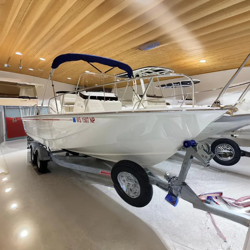 The Image of 2022 Boston Whaler 210 Montauk boat on trailer in showroom. - 0