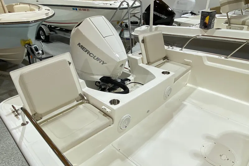 Slide: The Image of 2022 Boston Whaler 210 Montauk boat interior with Mercury engine and seating. - 5