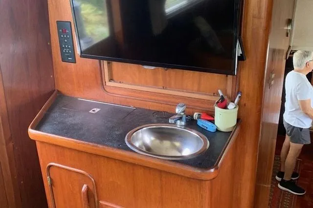 Slide: The Image of Interior of a 1985 Gulfstar MK2 with sink and television. - 14