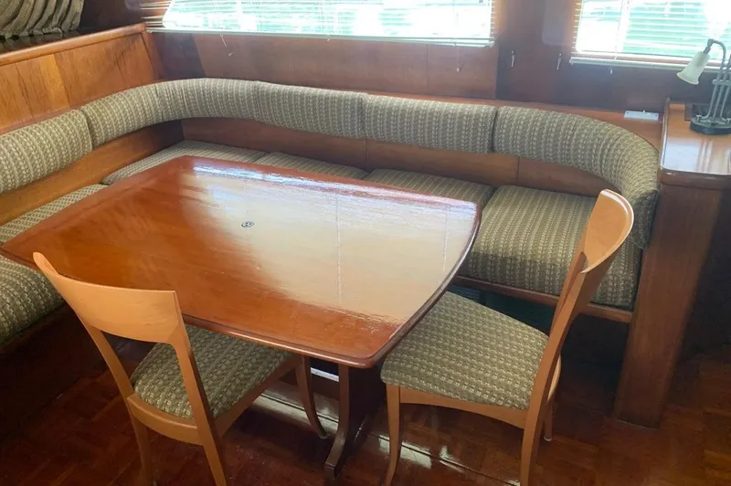 Slide: The Image of Interior of a 1985 Gulfstar MK2 yacht with dining table and seating area. - 2