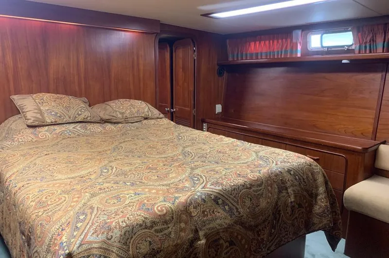 Slide: The Image of Luxurious cabin on 1985 Gulfstar MK2 with wood paneling and cozy bed. - 23
