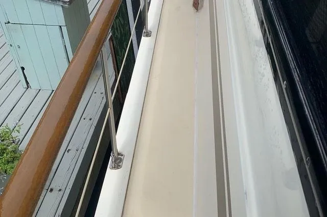 Slide: The Image of Deck of a 1985 Gulfstar MK2 boat with wooden railing. - 31