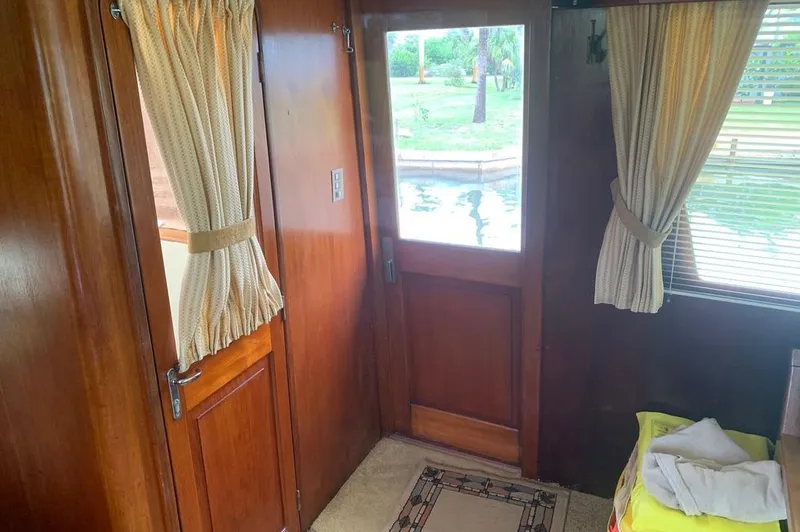 Slide: The Image of Interior of a 1985 Gulfstar MK2 with wooden doors and curtains. - 35