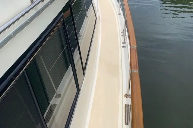 Slide: The Image of 1985 Gulfstar MK2 yacht deck with wooden railing and windows. - 39