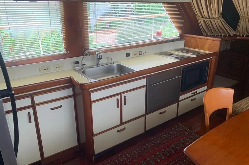 Slide: The Image of Gulfstar MK2 1985 kitchen with sink, stove, and microwave. - 5