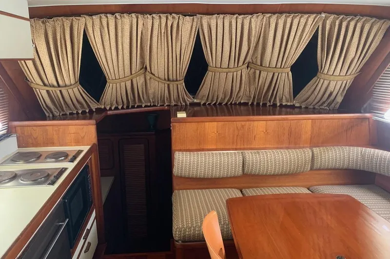 Slide: The Image of Interior of a 1985 Gulfstar MK2 yacht with kitchen and seating area. - 6